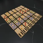 family playing wooden domino dot game together at home