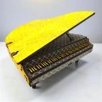 close up of the miniature wooden piano décor piece showing crafted keys and smooth finish