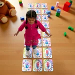 kids playing hopscotch floor game outdoors on garden or patio